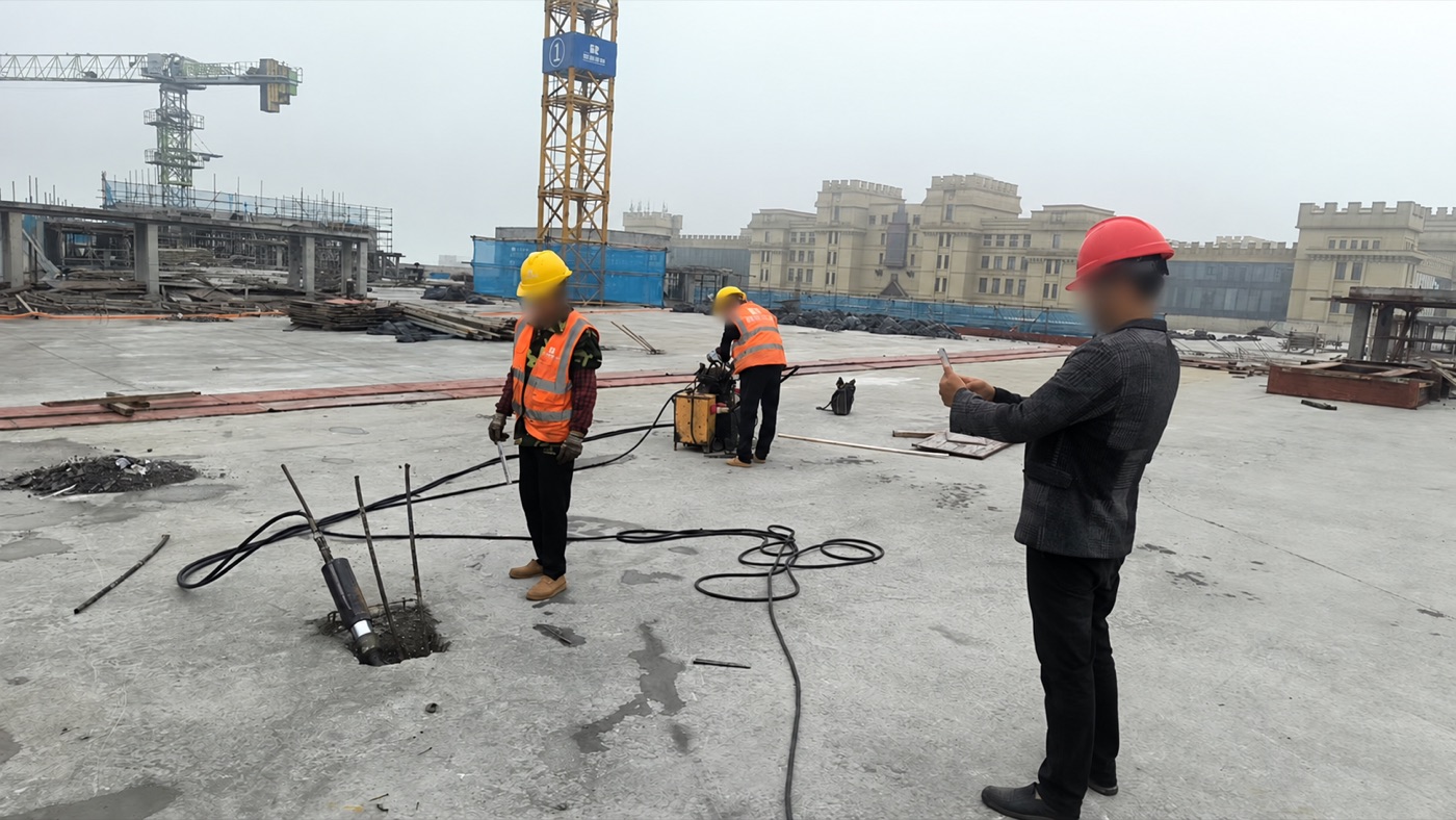 On-site unbonded prestressing operation; workers' faces have been obscured for privacy